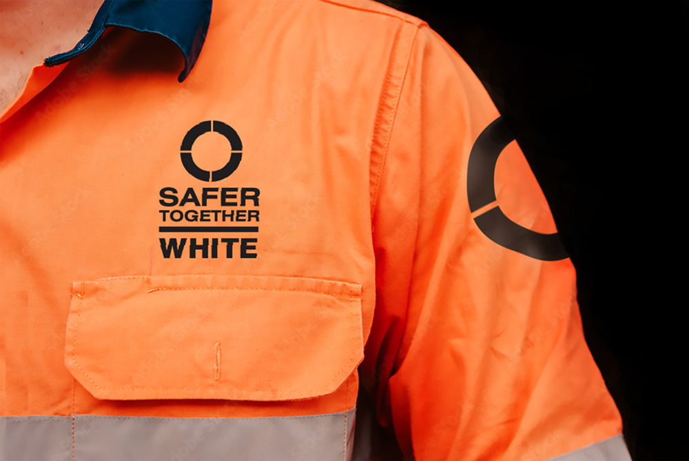 Bright orange reflective safety jacket with lSafer Together logo created by Stephen Charlton of Clarity. www.clarityaccelerated.com